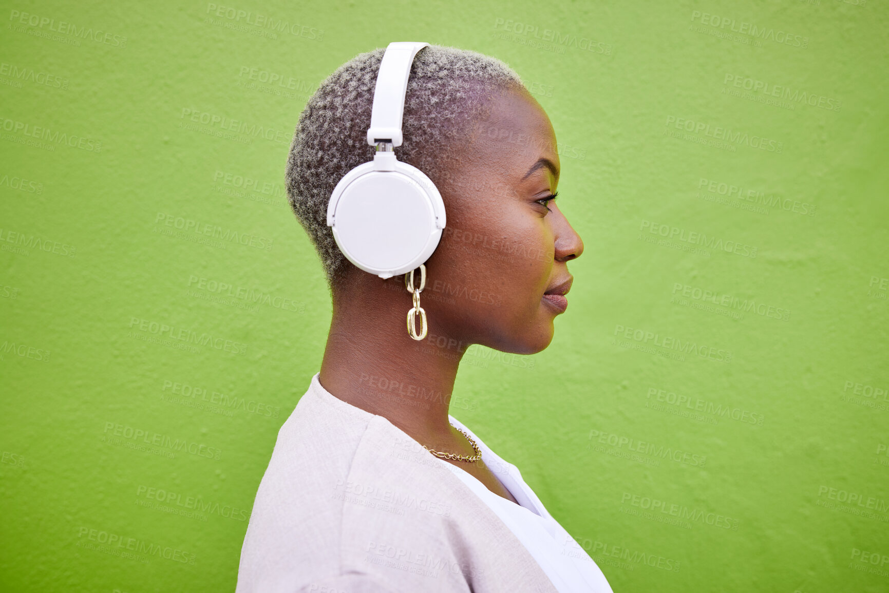 Buy stock photo Music headphones, profile and black woman listening on green wall background mockup space. Radio, serious and African person streaming podcast, hearing audio and sound of jazz media on technology.