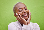 Laughing, black woman and self love or pride on a green wall for fashion, thinking or trendy. Smile, young and a calm African girl or fun model with confidence, fashion or peace on a background