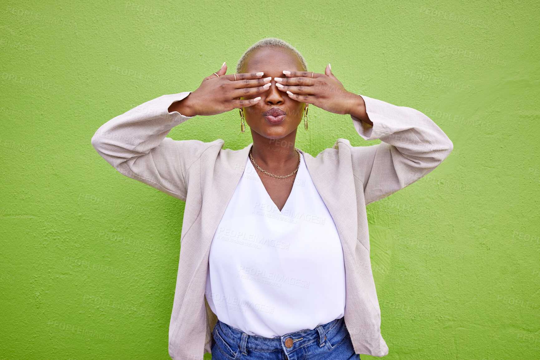 Buy stock photo Cover eyes, playful and a black woman on a green background for comedy, happiness or fun. Pouting, hide or an African girl or model with a shy expression, surprise or funny on a wall in the city