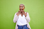 Excited, thinking and black woman surprise by news, deal or discount offer isolated in a studio green background. Wow, gossip and young person with emoji reaction to announcement or promotion