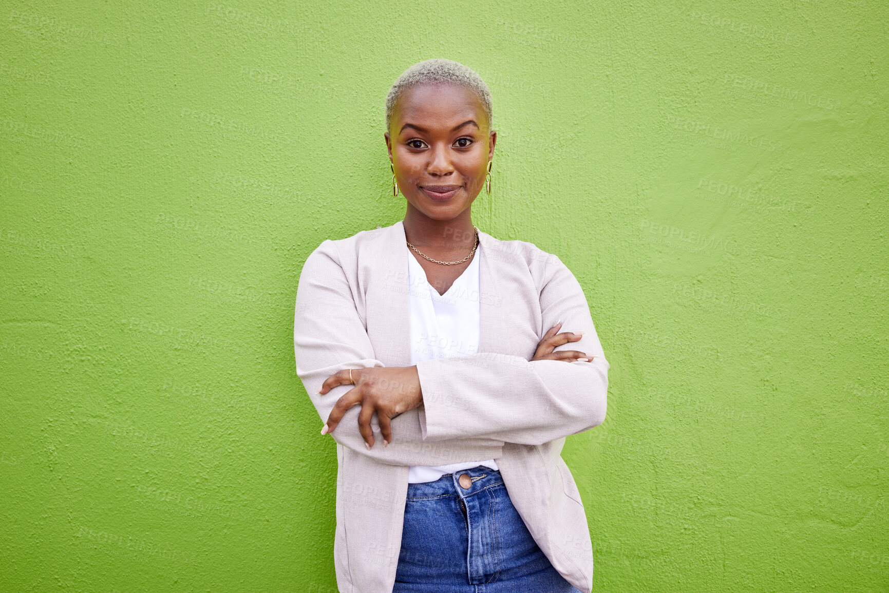 Buy stock photo Portrait, fashion and happy black woman with arms crossed on green wall background mockup space. Positive designer, smile and confident African person in style, casual clothes and trendy in Nigeria