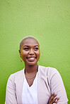 Happy, crossed arms and young black woman by a green wall with classy and elegant jewelry and outfit. Happiness, smile and African female model with positive and confident attitude with mockup space.