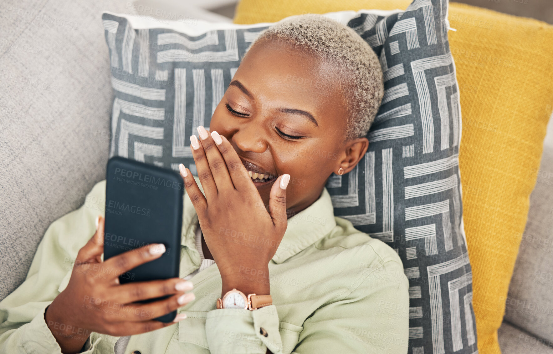 Buy stock photo Black woman on sofa with phone, laughing and meme on social media, message or video online. Happy face, smile and internet, girl on couch with digital app on smartphone and funny viral post in home.