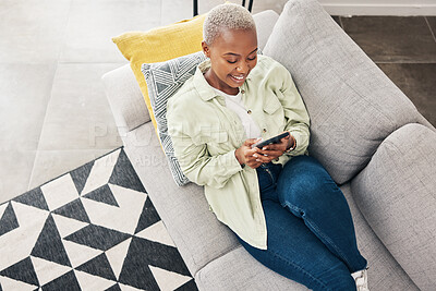 Buy stock photo Woman, relax and typing with phone on sofa for social media, chat and online contact at home from above. Happy african person, smartphone and download mobile games, digital multimedia and dating app