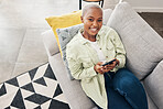 Woman, portrait and relax with phone on couch for social media, text chat and contact at home from above. Happy african person, smartphone and download mobile games, digital multimedia and dating app