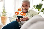 Notification, overlay and black woman with phone on sofa for social media, chat or emoji reaction at home. Smartphone, app and happy female influencer smile for online dating, blog or podcast content