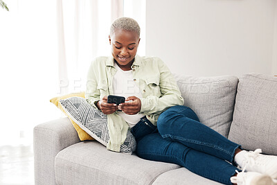 Buy stock photo Happy black woman, smartphone and typing on sofa for social media post, digital contact and reading notification. Cellphone, mobile games and scroll online shopping app to search subscription at home