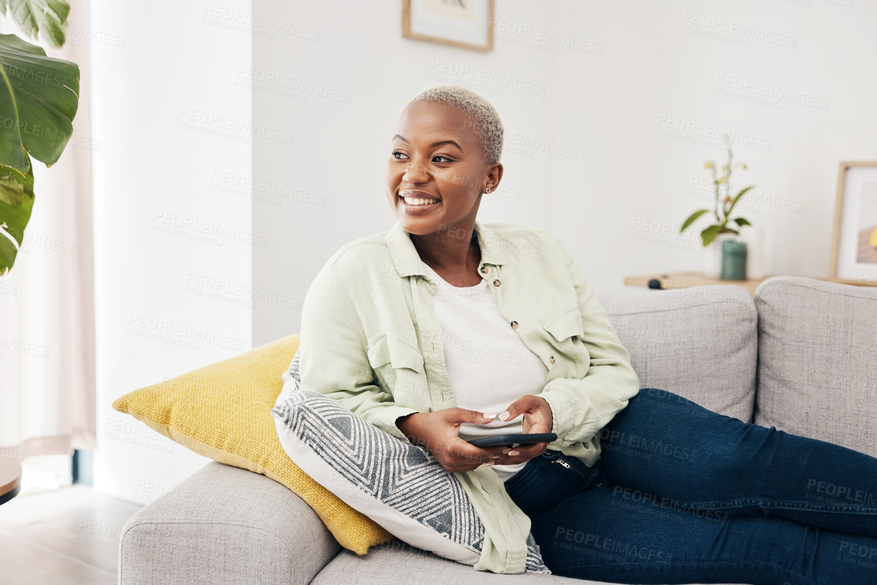 Buy stock photo Woman, happy and thinking with phone on sofa to relax with social media, digital contact and user connection. African person, smartphone and idea for mobile blog, search subscription and app at home