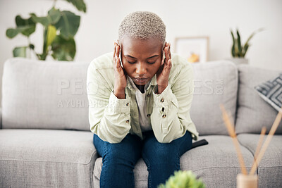 Buy stock photo Anxiety, headache and pain with a black woman on a sofa in the living room of her home for mental health. Stress, burnout or vertigo and a young person in an apartment with depression or a migraine