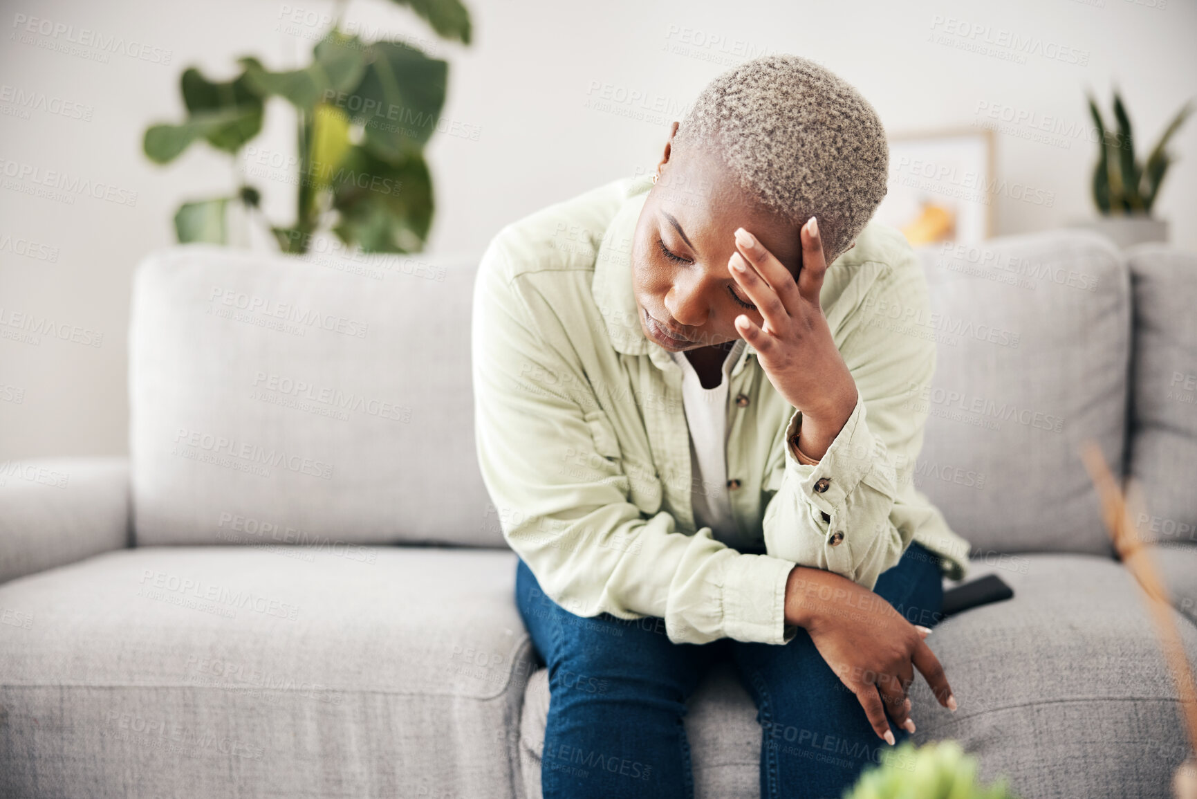 Buy stock photo Woman, depression and headache in home for anxiety, mental health and stress of mistake, debt or crisis. Tired, sad and frustrated african person with emotional trauma, broken heart and worry on sofa