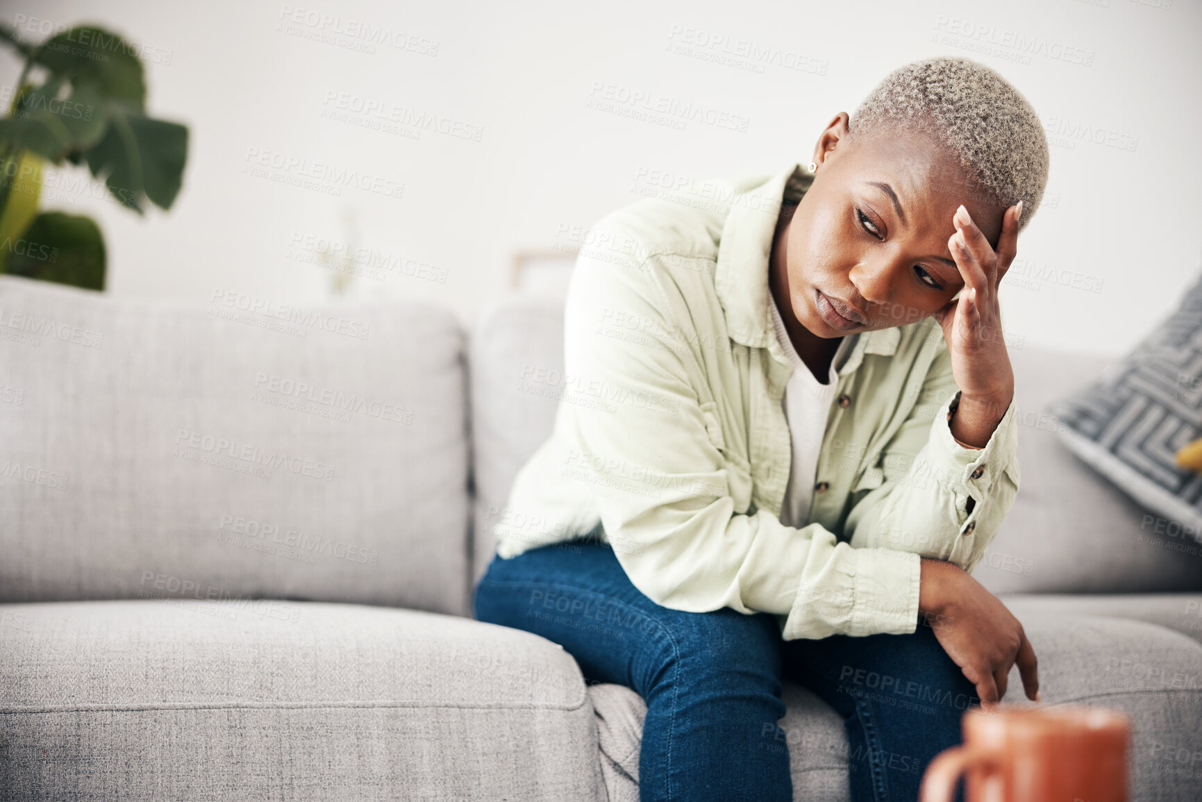 Buy stock photo Woman, depression and thinking in home of pain, mental health or anxiety of debt, regret or risk. Stress, worry and frustrated african person with headache of sad trauma, broken heart or ptsd on sofa