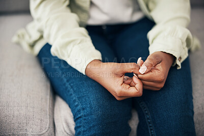 Buy stock photo Anxiety, hands and woman on a sofa with stress, worry or mental health crisis in her home. Depression, trauma and zoom on female with bipolar, fear or abuse, danger or nervous nail picking habit