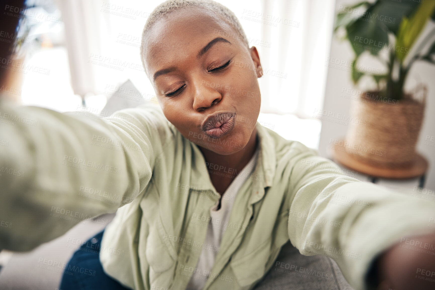 Buy stock photo Home, face or black woman taking a selfie with a kiss or pout on sofa to post on social media. Apartment, house or African person taking a photo, vlog or picture on couch in living room to relax 