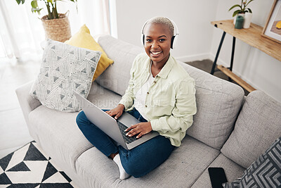 Buy stock photo Portrait of black woman, remote work or laptop on sofa in living room for online research in headphones. Happy, top view or journalist working on computer for streaming or social media blog at home