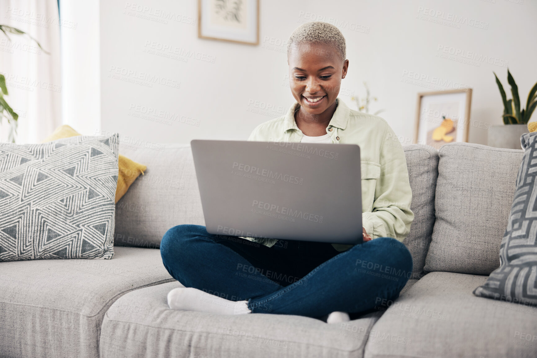 Buy stock photo Happy, relax and a black woman on the sofa with a laptop for a movie, streaming a show or chat. Smile, house and an African girl typing on a computer on a couch for an email, communication or a blog