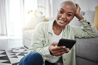 Buy stock photo Woman, portrait and typing on smartphone on living room floor for social media post, search contact or download mobile games. Happy african person, cellphone and subscription on digital app at home 