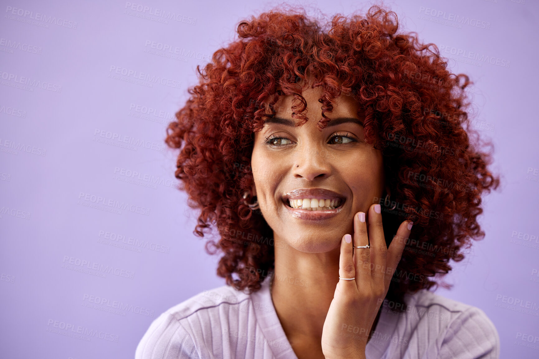 Buy stock photo Beauty, hair and woman with hands on face in studio for natural, cosmetic or wellness on purple background. Haircare, portrait and lady model smile for red afro growth, texture or dye satisfaction