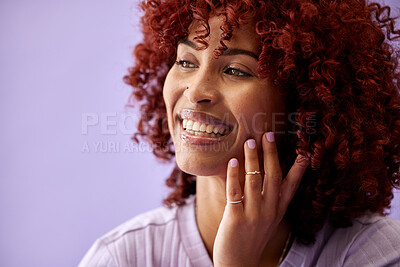 Buy stock photo Makeup, hair and beauty transformation for woman in studio with hands on face for cosmetic results on purple background. Makeover, smile and female model with red afro, dye or texture satisfaction