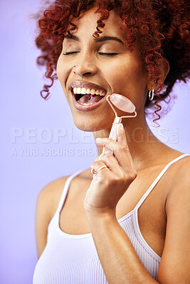 Buy stock photo Skincare, rose quartz and woman in studio for wellness, anti aging or collagen circulation on purple background. Crystal, beauty and lady model with jade roller facial, massage or lymphatic drainage