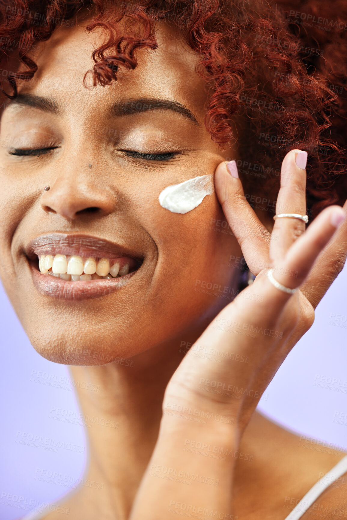 Buy stock photo Beauty face, eyes closed and happy woman with cream application, melasma treatment or collagen skincare product. Hydration lotion, sunscreen and girl smile for studio acne creme on purple background