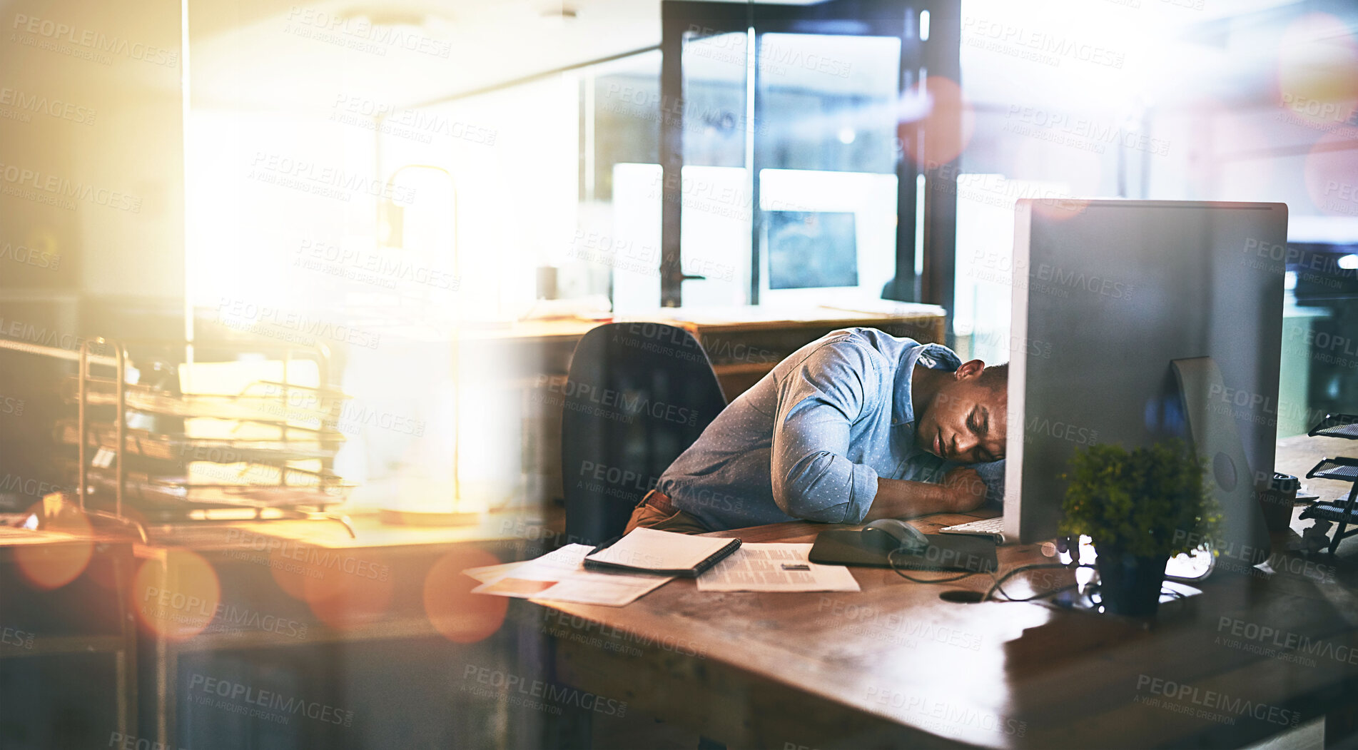 Buy stock photo Tired, black man and sleeping on desk in office with fatigue and burnout of depression and mental health. Exhausted, person and stress with lens flare, anxiety and risk lying on table at work
