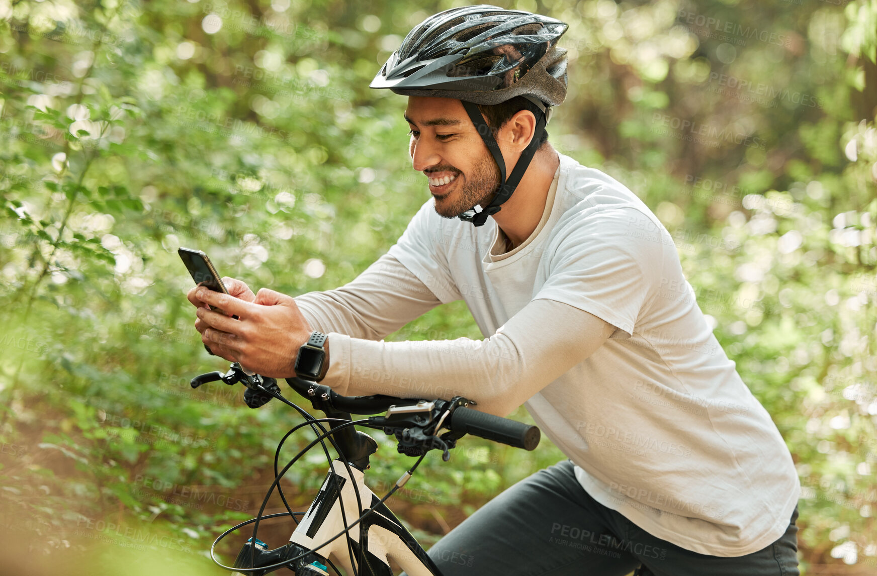 Buy stock photo Man, forest and phone on bike, texting and smile for web chat notification on adventure in nature. Guy, cycling and smartphone for contact with bicycle, relax and social media app in woods on blog