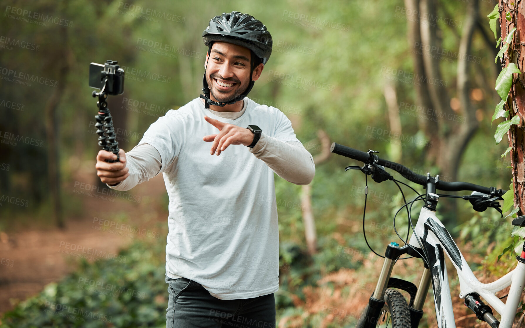 Buy stock photo Man, bike and forest with selfie, smile and pointing with wellness, training and exercise on adventure. Influencer guy, cycling and bicycle with profile picture, memory or live stream on social media