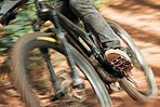 Feet, mountain bike pedal and speed in forest, closeup and training for health, wellness and outdoor adventure. Person, cycling and bicycle with fast race, exercise and workout with balance off road