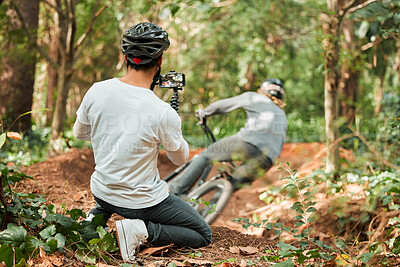 Buy stock photo Man, bike and forest with photographer, speed and phone for race, cycling video or post on web blog. Guy, bicycle and recording for vlog, live streaming or social media in woods for outdoor sports