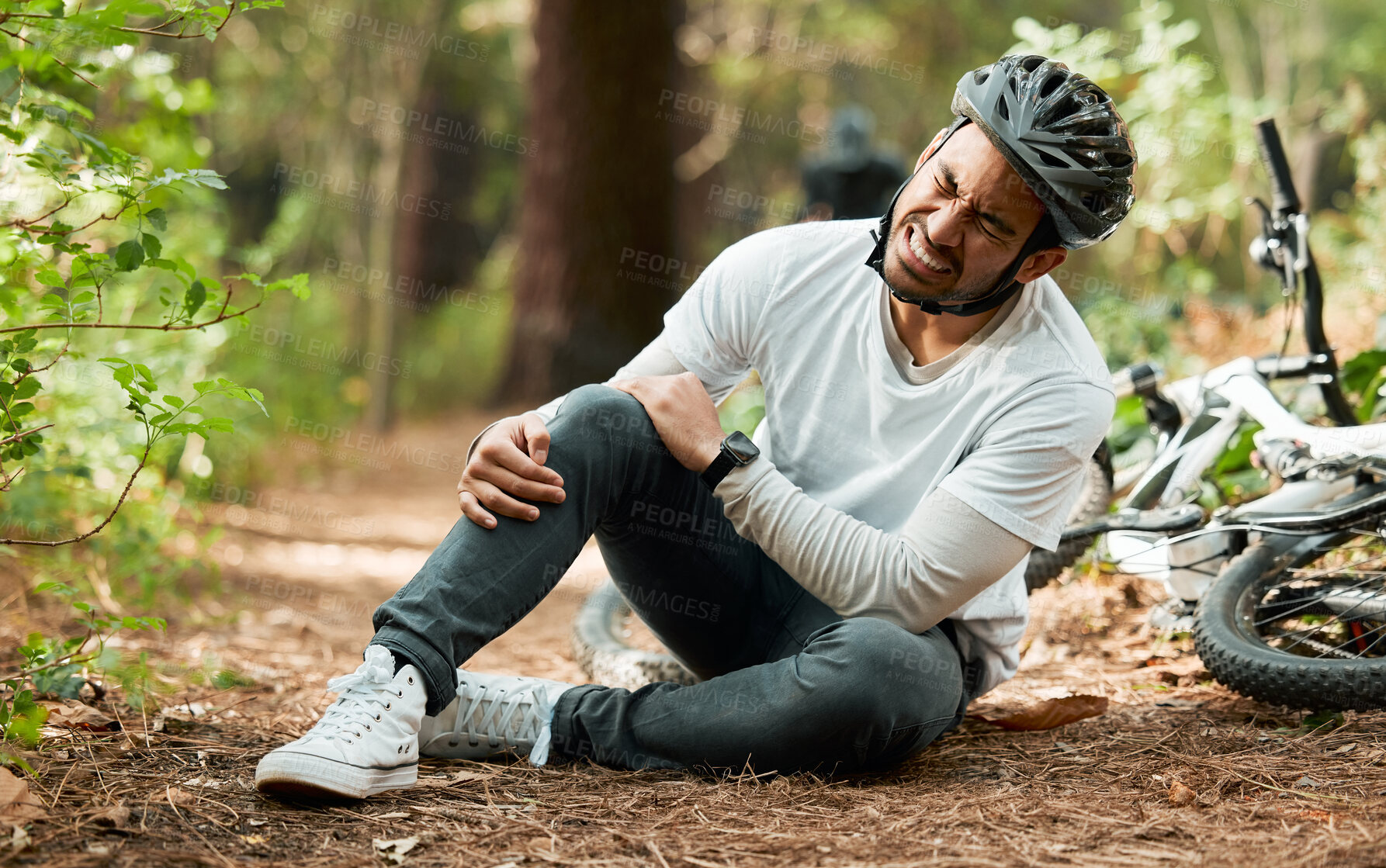 Buy stock photo Man, knee pain and injury in forest with bike, stress and sitting on ground with emergency in nature. Cycling athlete, young guy and accident with bicycle, training and exercise with crash in woods