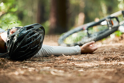 Buy stock photo Sports, fitness and cycling accident with a man on the ground while training for a race in the forest. Exercise, crash and fall with a cyclist unconscious in the woods during a nature workout closeup