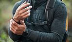 Wrist, pain and hands of man hiking, outdoor and exercise with a medical accident, crisis or problem with anatomy in nature. Training, injury and athlete with trauma to muscle, joint or hand 