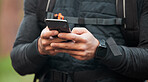 Closeup, man and runner with a cellphone, typing and connection with tracking progress, network or contact. Person, runner or hands with digital app, smartphone or break with fitness and social media