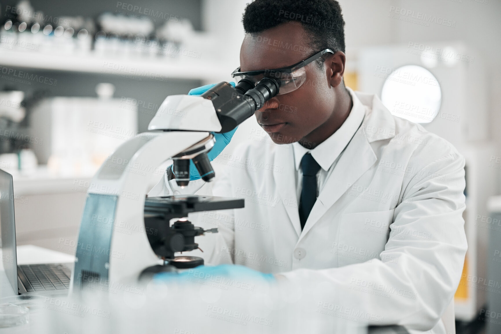 Buy stock photo Microscope, black man or biotechnology with research, medical or data analysis with experiment. African person, scientist or researcher with laboratory equipment, testing sample or dna with pathology