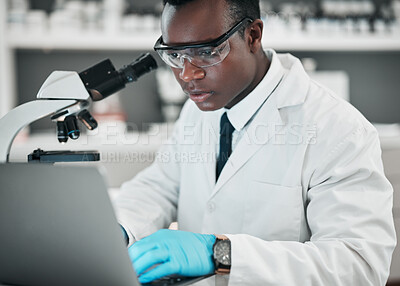 Buy stock photo Science, laptop and black man with research, medical and microscope with healthcare, typing and chemistry. African person, biologist or scientist with a computer, laboratory equipment and digital app