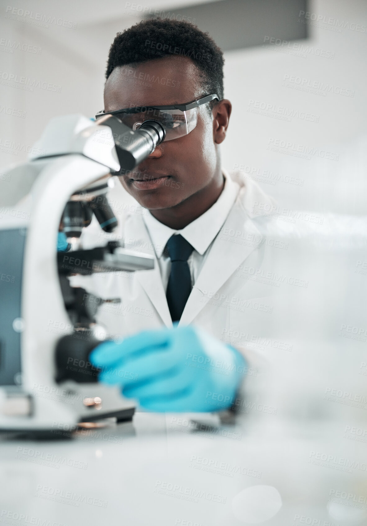 Buy stock photo Microscope, black man and analytics with research, medical and experiment for vaccine, test or sample. African person, scientist or researcher with lab equipment, pathology or biotechnology with cure