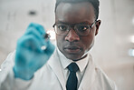 Scientist, writing and planning on glass in laboratory research, problem solving or solution of medical health. African man for science formula or brainstorming math, data or ideas on window or board