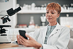 Medical science, woman and a phone in a laboratory for online communication, email or website. Mature scientist person with smartphone typing medicine research, results or network database app