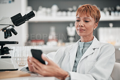 Buy stock photo Medical science, woman and a phone in a laboratory for online communication, email or website. Mature scientist person with smartphone typing medicine research, results or network database app