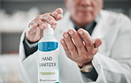 Doctor, sanitizer bottle and cleaning hands for risk, hygiene and protocol in hospital, clinic and surgery. Closeup, healthcare worker and disinfection liquid for safety, flu germs and virus bacteria