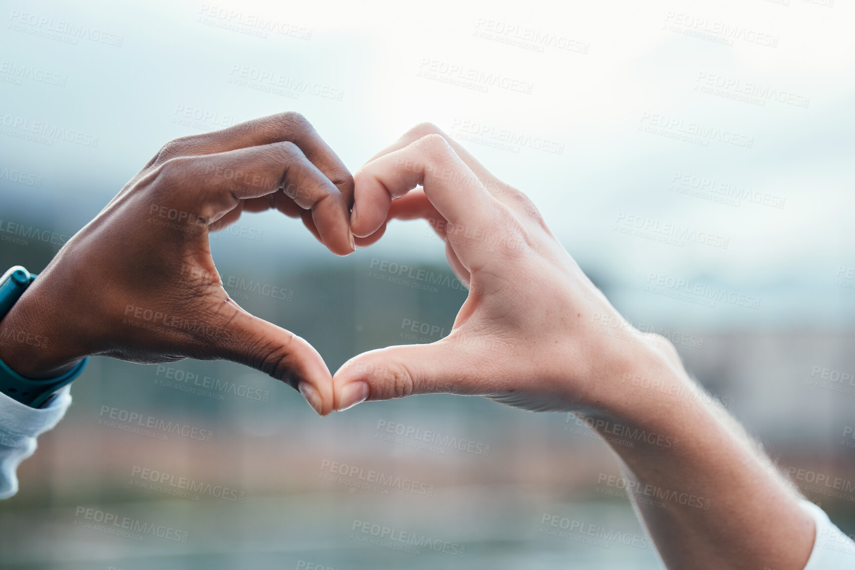 Buy stock photo Outdoor, closeup and people with heart sign, hands and support with kindness, emoji and commitment. Outside, couple or interracial with symbol for love, trust and partnership with care, icon and like