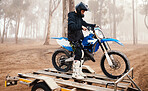 Motorbike, man and sports in forest with training for competition, riding in nature with action and helmet. Extreme, adrenaline and exercise, athlete and transport with dirt bike, freedom and travel