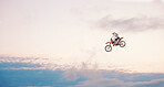 Motorcycle, sky background and competition for adventure, freedom and exercise with safety gear. Bike, jump and talent for training with fitness, balance or challenge in nature on mock up space
