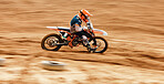 Motorcycle, driving and motion blur with a man on space in the desert for dirt biking. Bike, fitness and power with a fast person on an off road course for sports, freedom or performance challenge