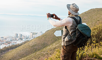 Buy stock photo Phone, hiking and photography of black man in nature, adventure and travel on holiday vacation. Mobile, picture of city and person trekking outdoor, tourist journey and view of countryside landscape