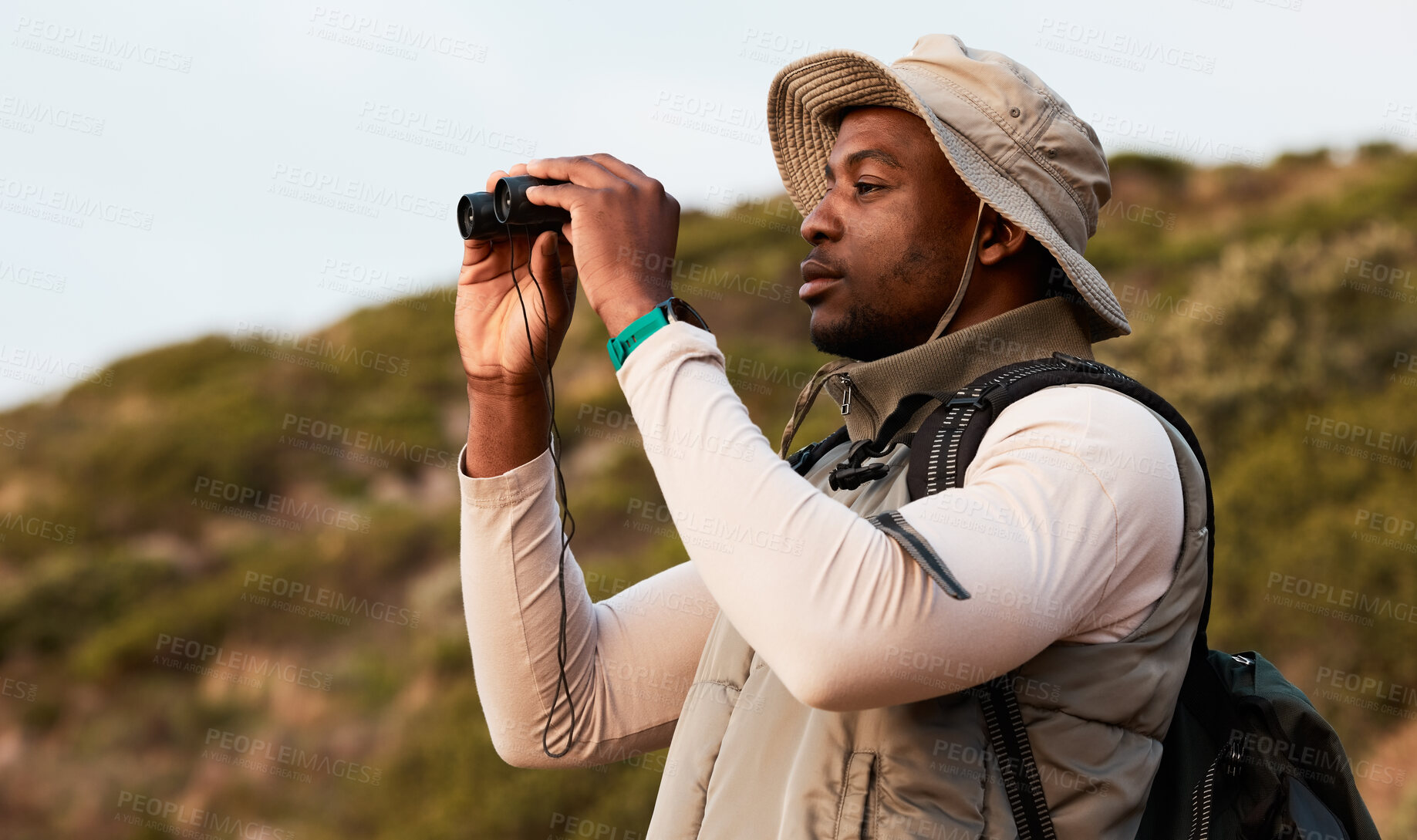 Buy stock photo Hiking, binocular or black man on mountain in nature on trekking journey or adventure for freedom. View, holiday vacation or African hiker walking to search in park for exercise, fitness or wellness