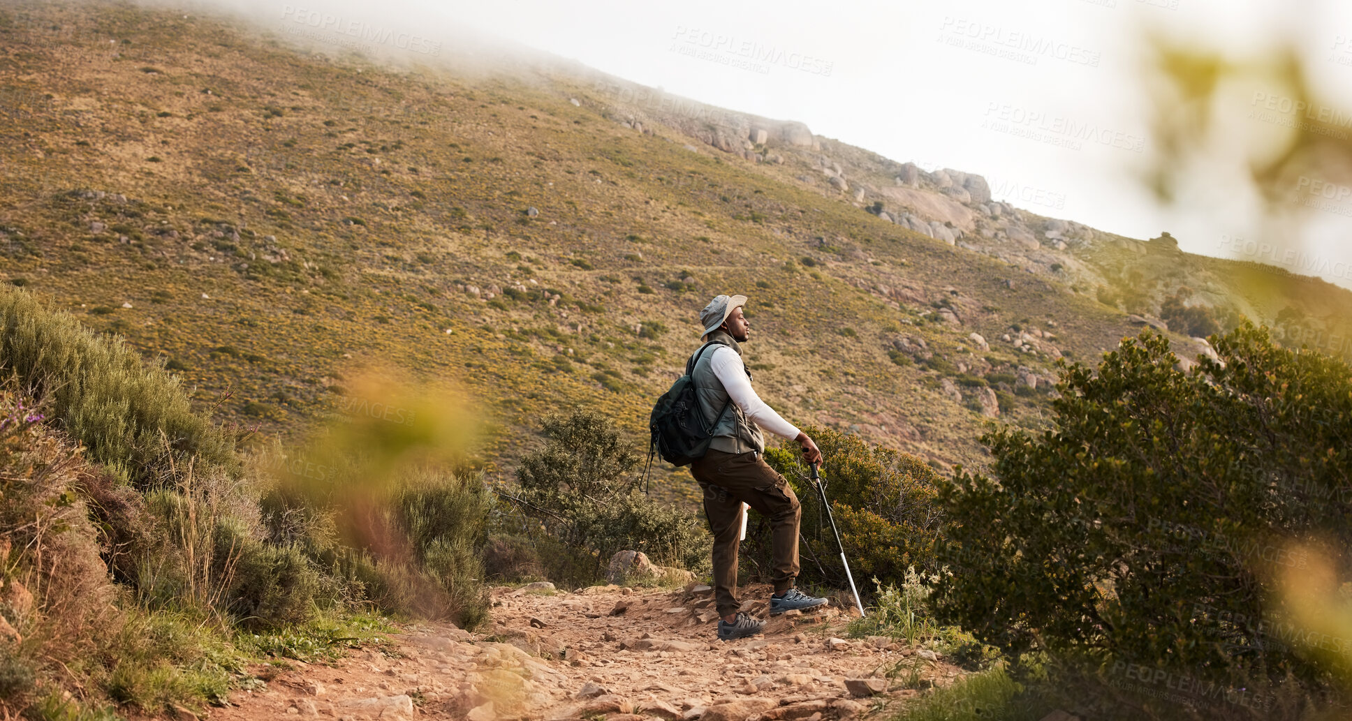 Buy stock photo Hiking, thinking or black man on mountain in nature for trekking journey or adventure for freedom. Stick, holiday vacation or African hiker on walking break in park for exercise, fitness or wellness