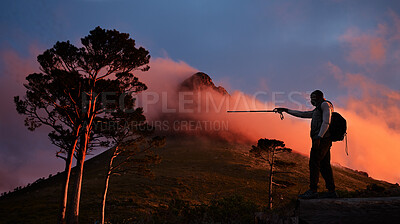 Buy stock photo Goal, pointing and a man hiking in the mountains at night for travel, freedom or to explore remote nature. Sky, motivation and dark with a backpacker trekking in the forest for adventure on space