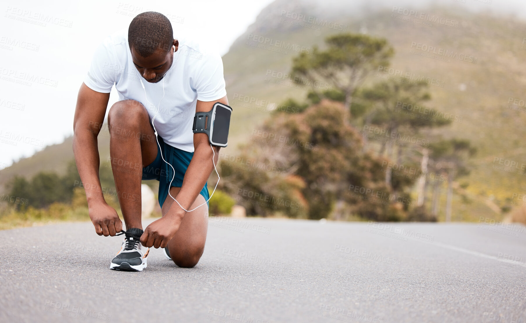 Buy stock photo Fitness, tie or runner with shoes on a road by nature for exercise, training or outdoor workout. Sports race, black man or healthy athlete on street with footwear or headphones for streaming music