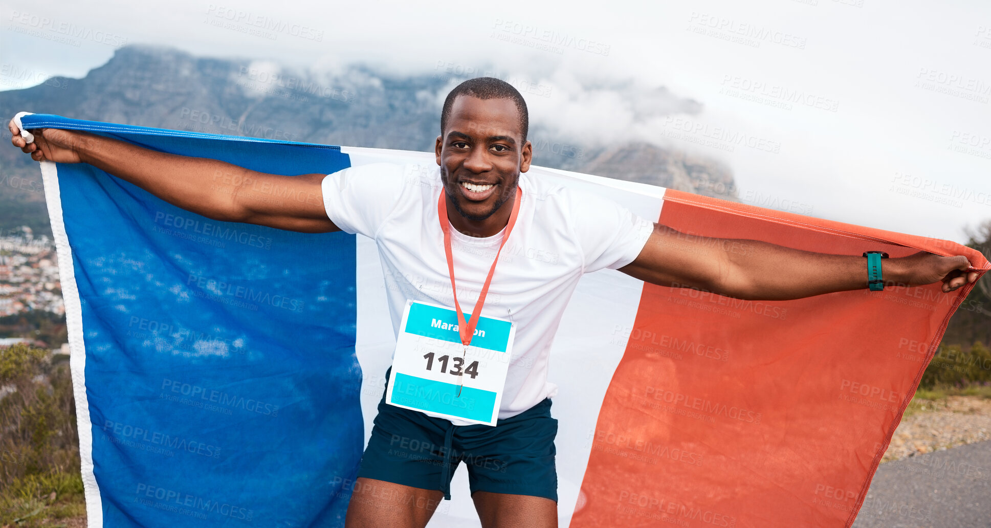 Buy stock photo Runner man, flag and winner in portrait, pride and celebration for marathon, fitness and sports in street. Black guy, athlete and fabric for national sign, success or achievement at race in Cape Town